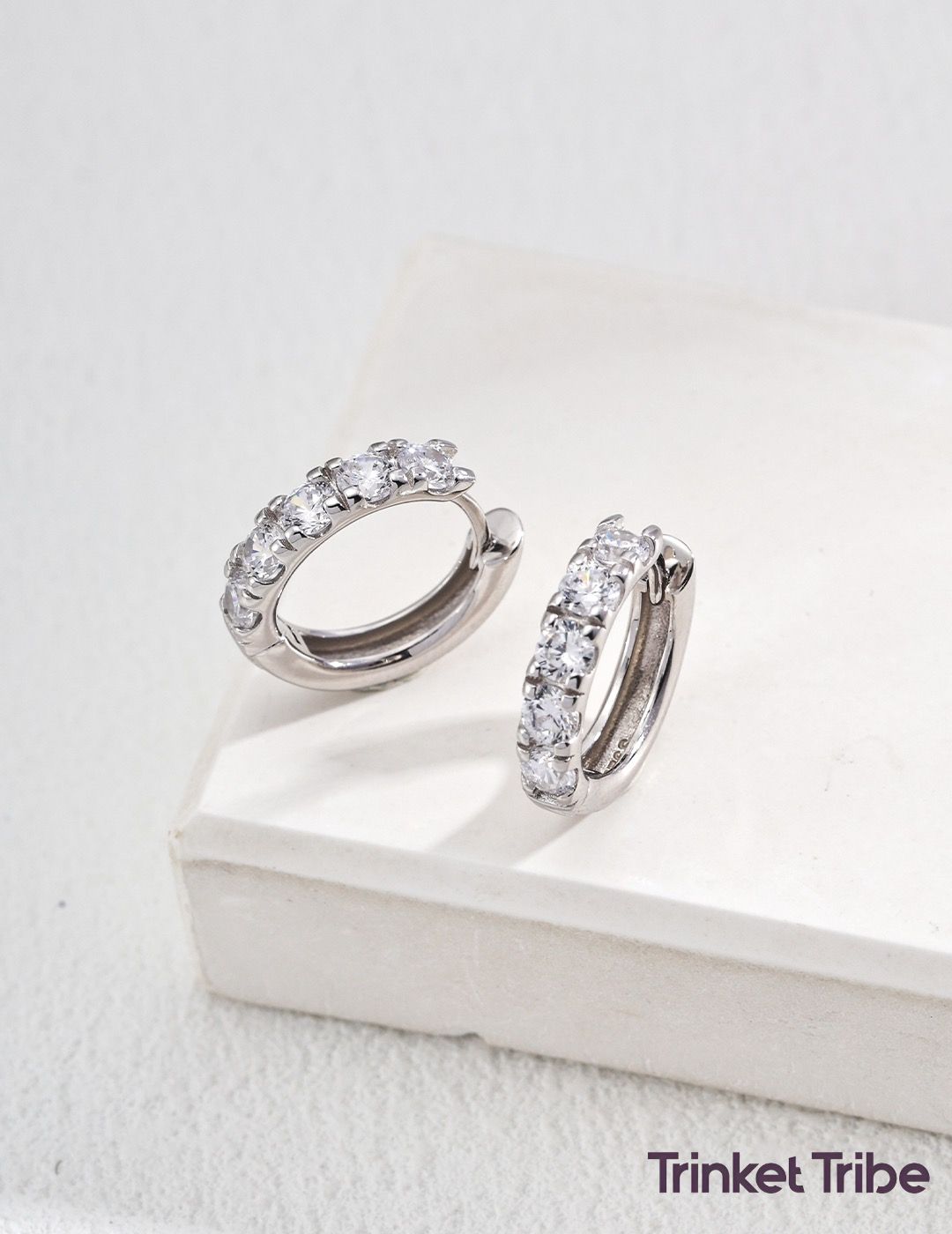 Sterling silver huggie hoop earrings adorned with sparkling clear zircon stones, dainty and modern accessory for daily styling or gifting.