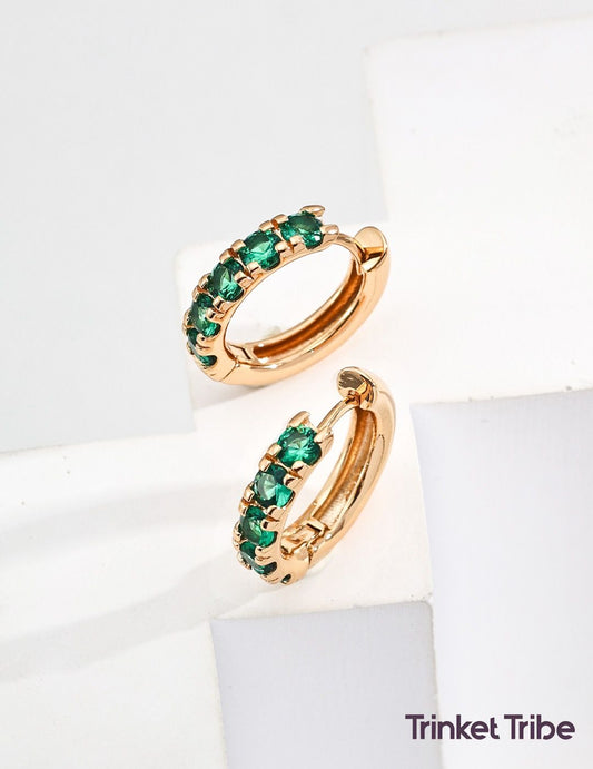 Gold huggie hoop earrings with vibrant green zircon stones, minimalist and elegant jewelry perfect for everyday wear or stacking